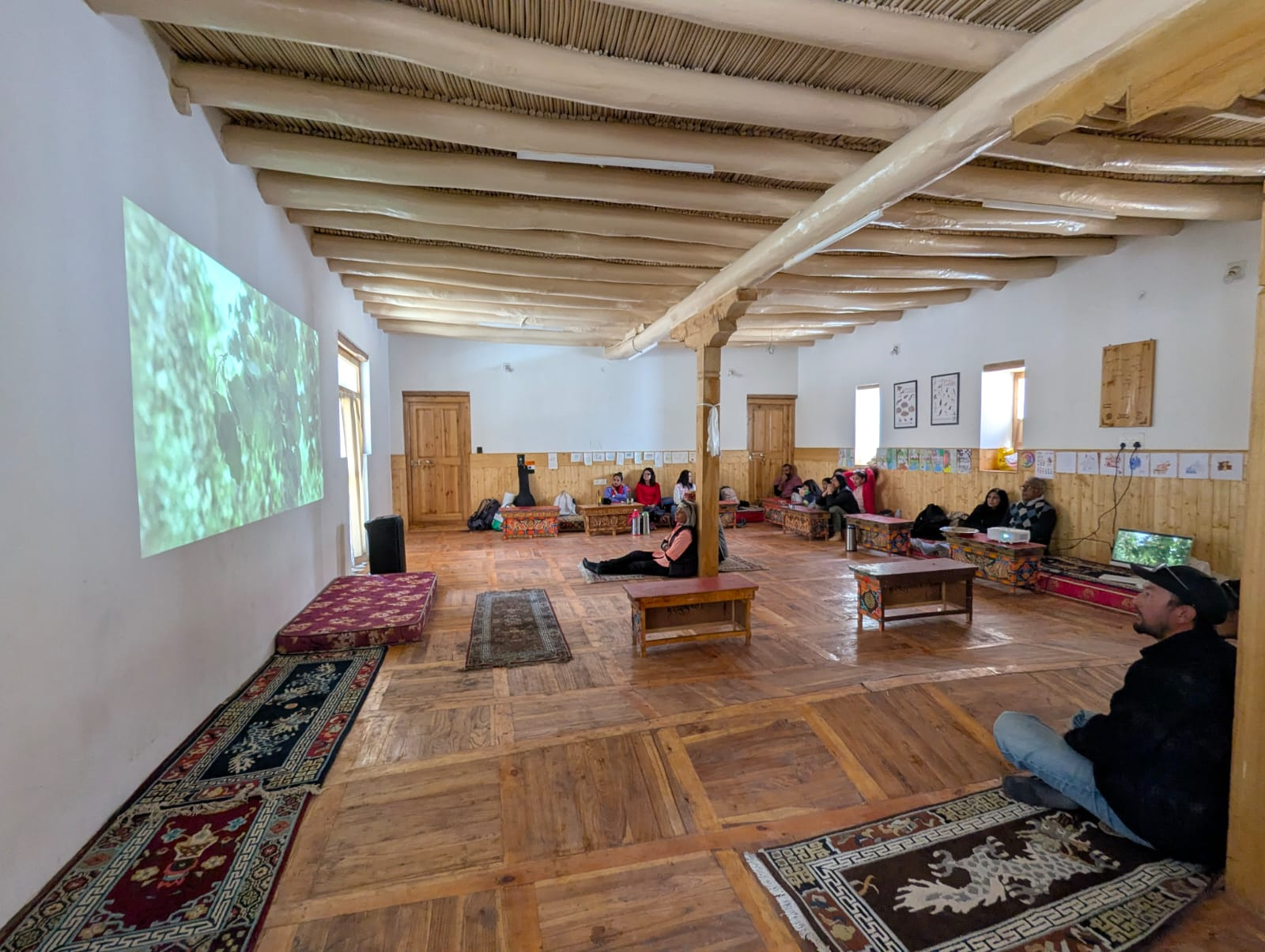 Community gathered around low wooden tables